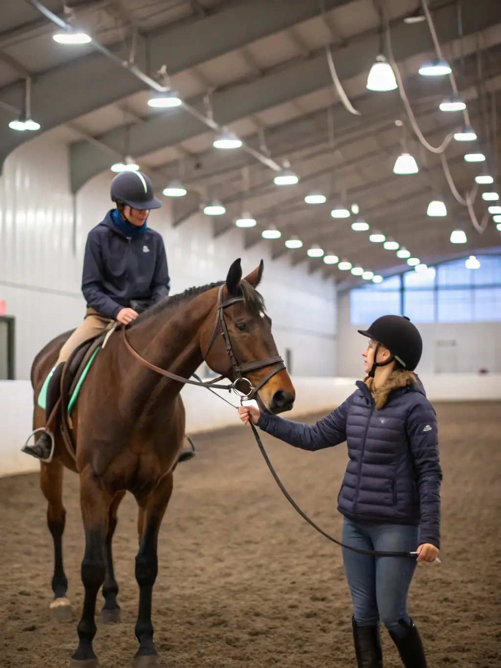 A skilled equestrian instructor guiding a beginner rider during a training session at the Saint-Cyr du Doret stable, emphasizing safety and skill development.